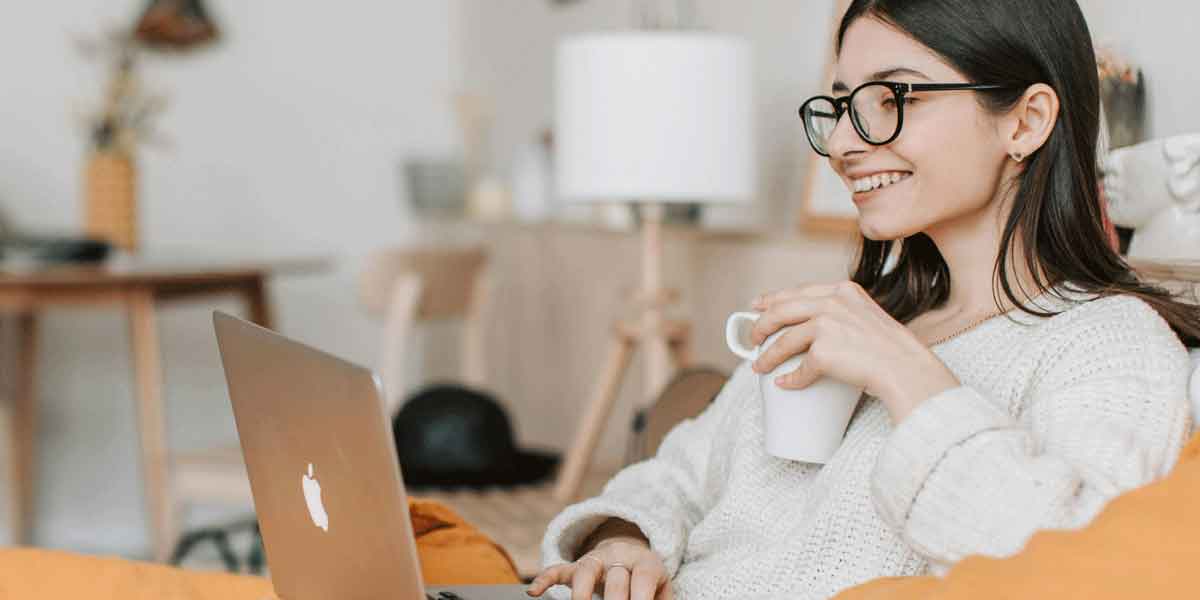 someone using pc for shopping while drinking coffee